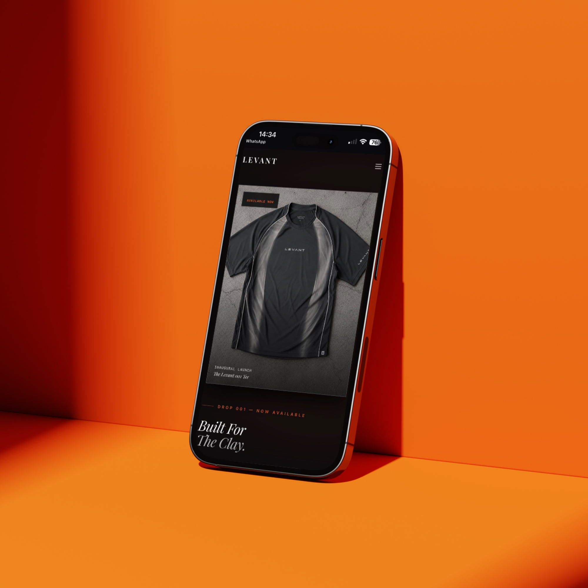 LEVANT — the 001 tee product page open on a phone against an orange set